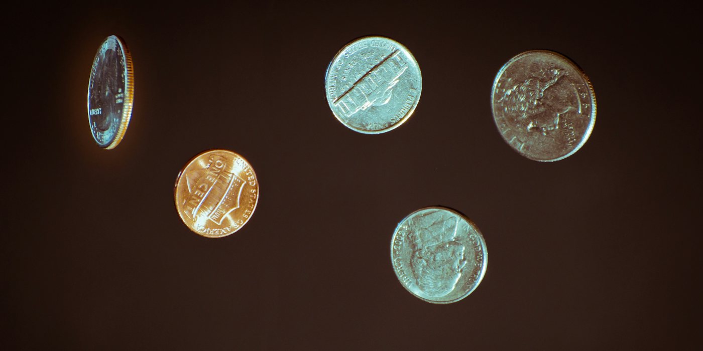 silver round coins on white surface