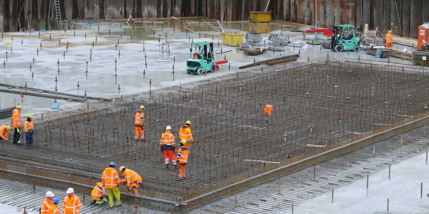 a group of construction workers standing around a construction site
