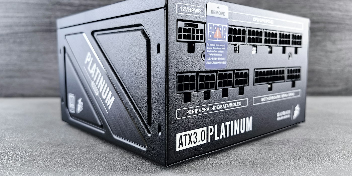 A black modular ATX power supply with a platinum efficiency badge sitting on a desk